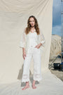 White cropped wide-leg jeans with broderie cutwork and scalloped hems