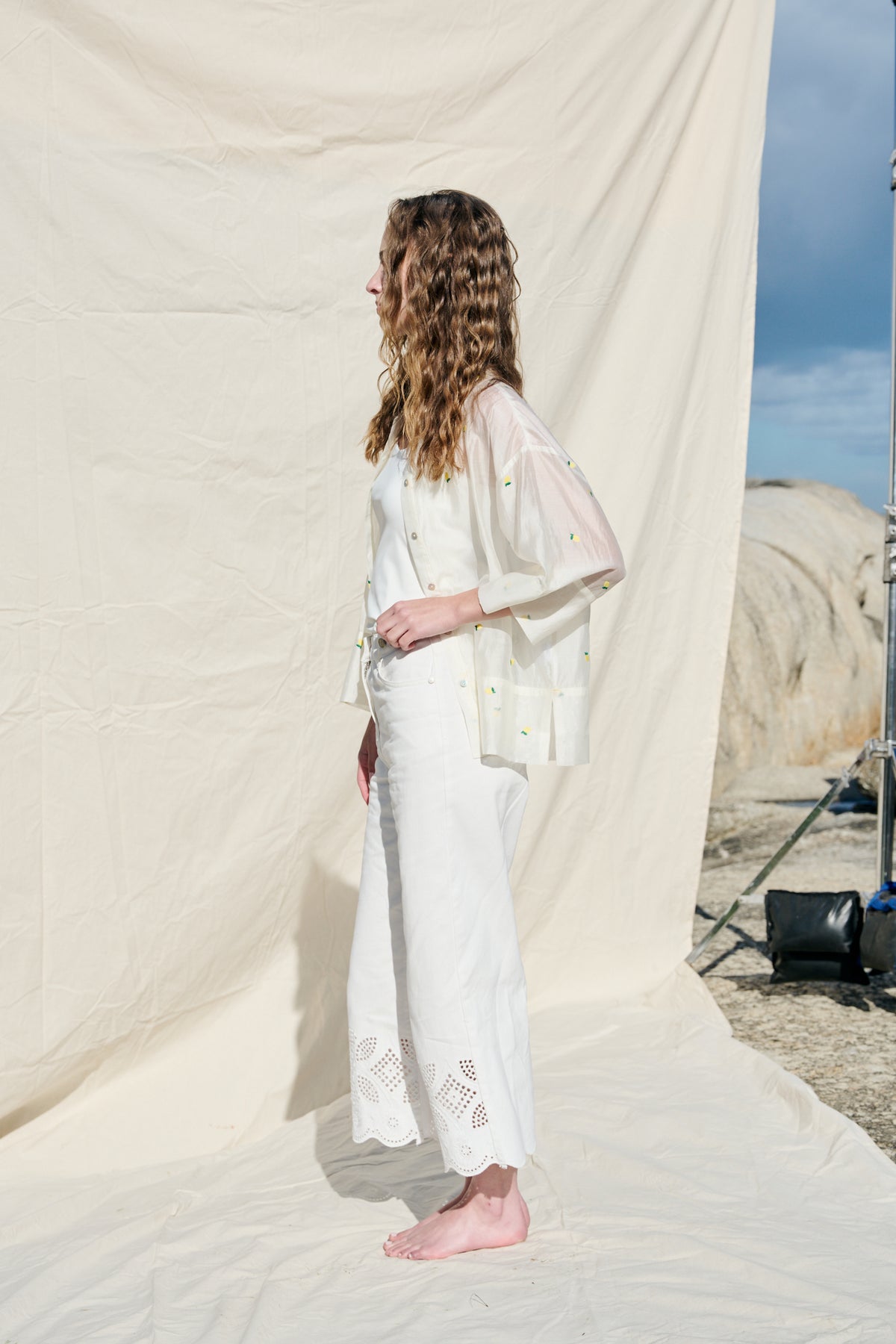 White cropped wide-leg jeans with broderie cutwork and scalloped hems