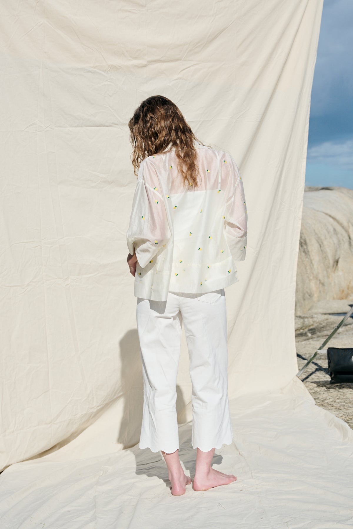 White cropped wide-leg jeans with broderie cutwork and scalloped hems