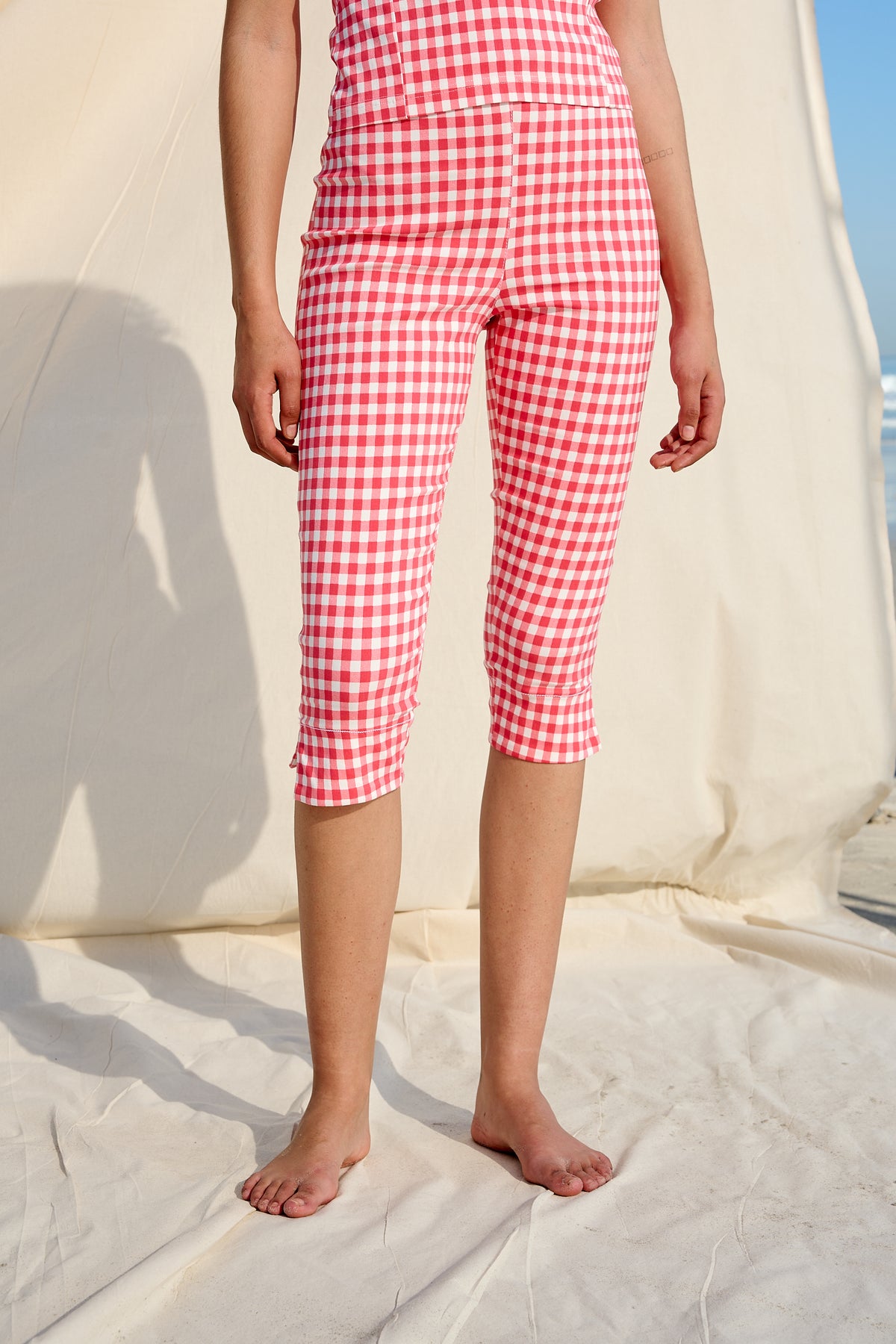 Red and white gingham capri pants with a fitted cut and side slits