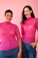 Models wearing a pink polo mesh 3/4 sleeve top and jeans 
