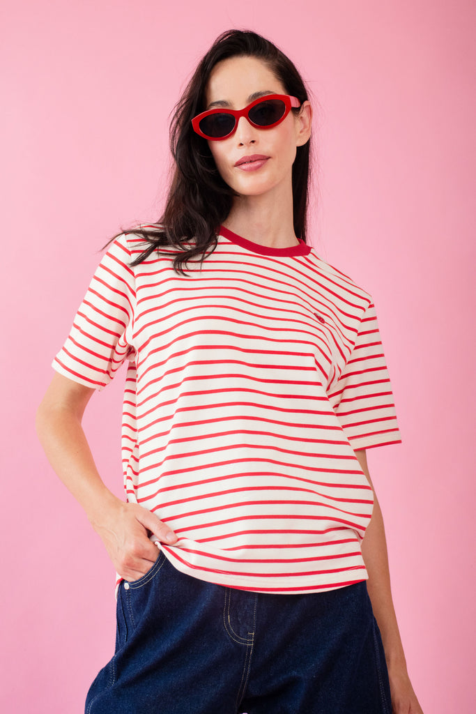 Model wearing strawberry tee with milk and red stripe