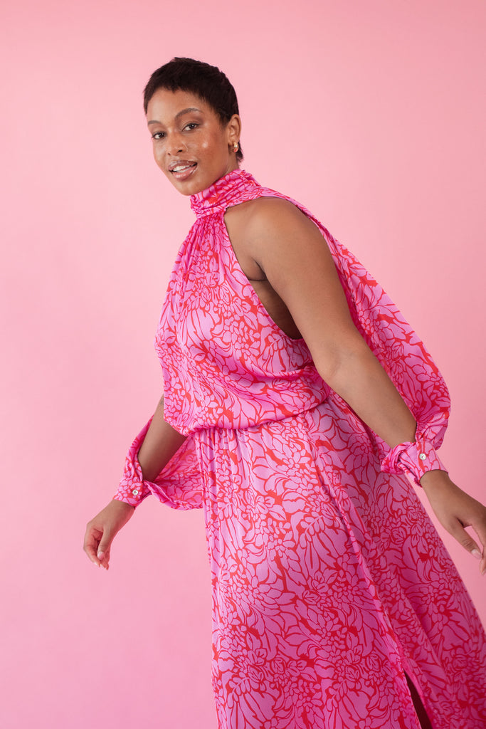 Model wearing pink and red, floral print dress