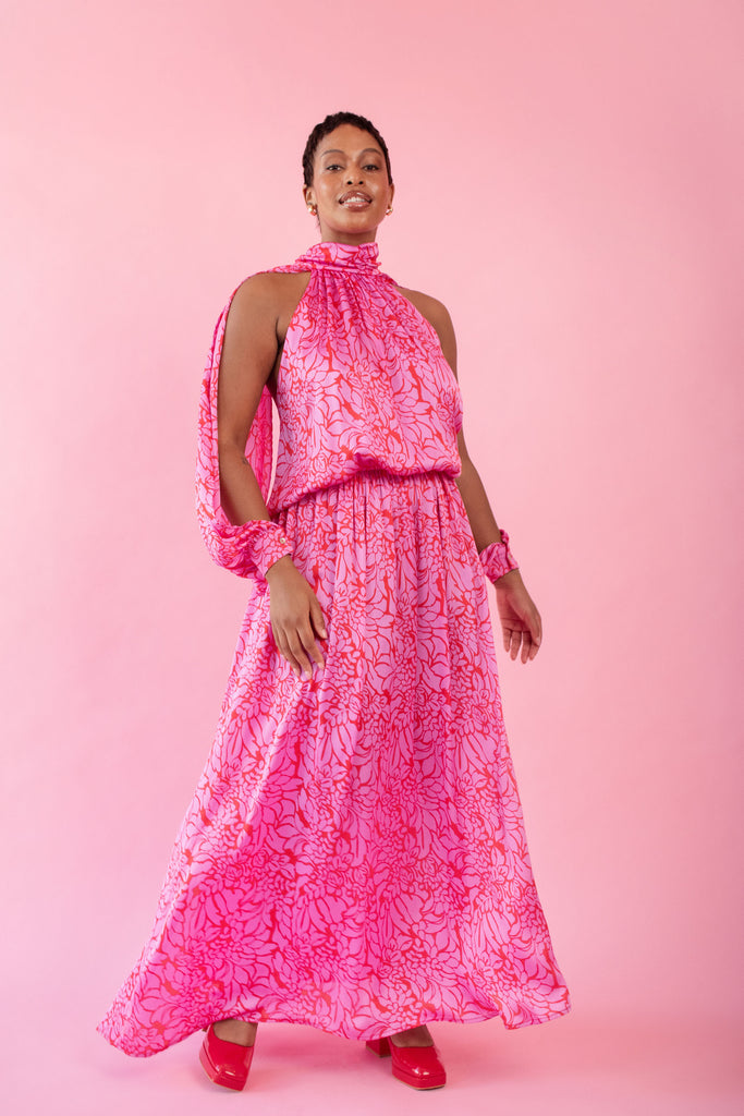 Model wearing pink and red, floral print dress