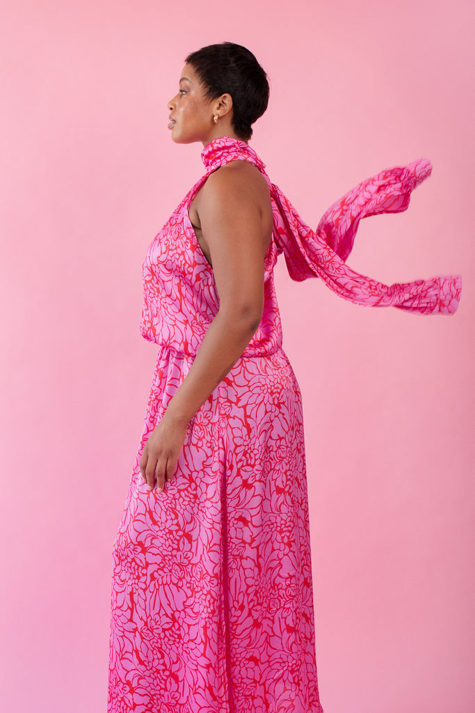 Model wearing pink and red, floral print dress