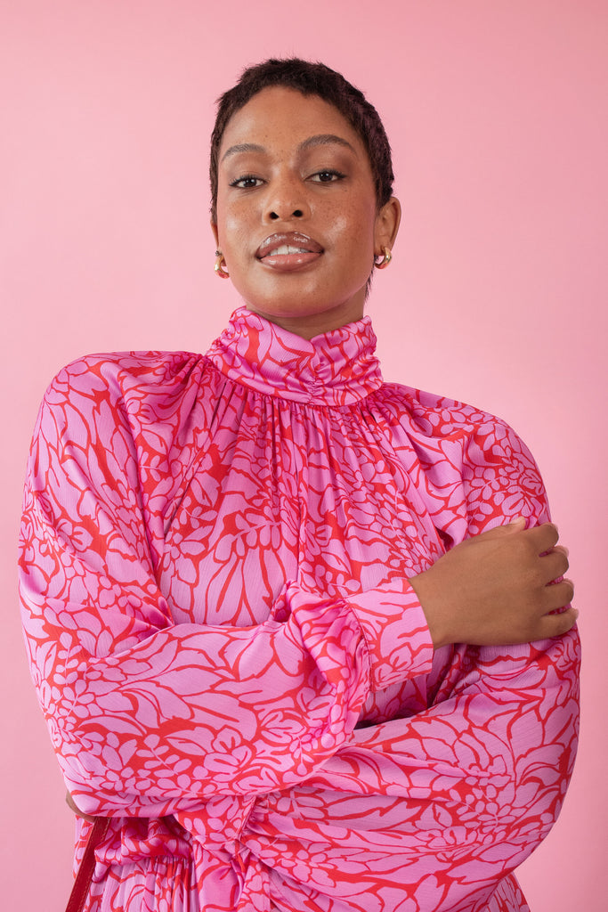 Model wearing pink and red, floral print dress