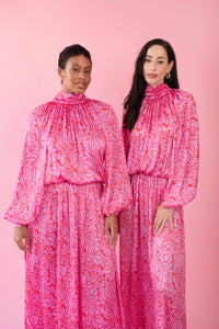 Models wearing pink and red, floral print dress
