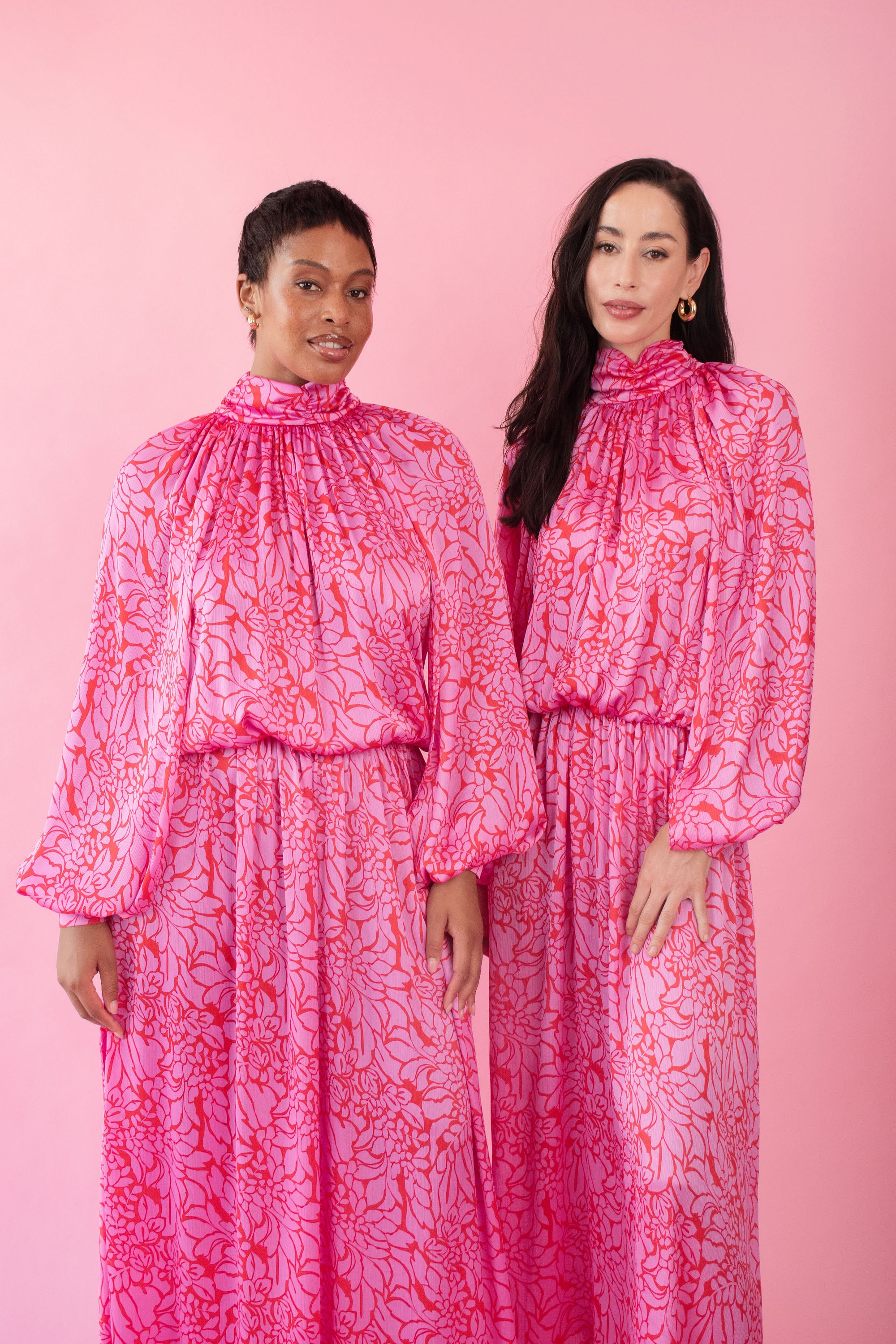 Models wearing pink and red, floral print dress