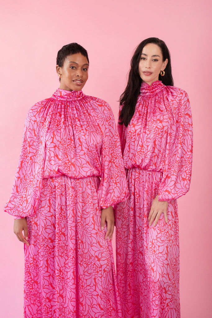 Models wearing pink and red, floral print dress