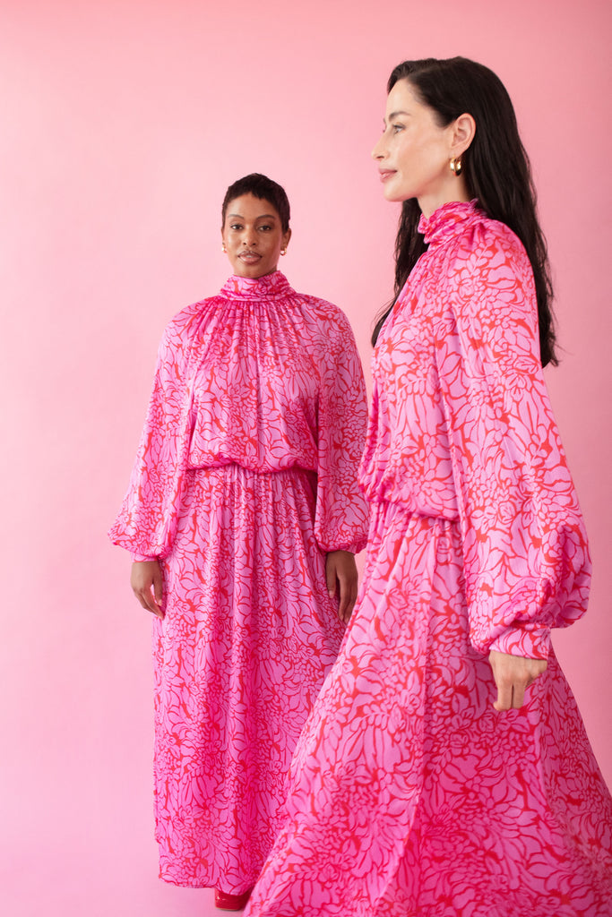 Models wearing pink and red, floral print dress