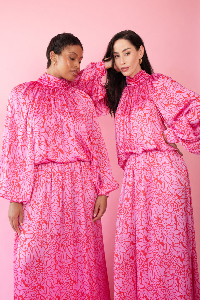 Models wearing pink and red, floral print dress