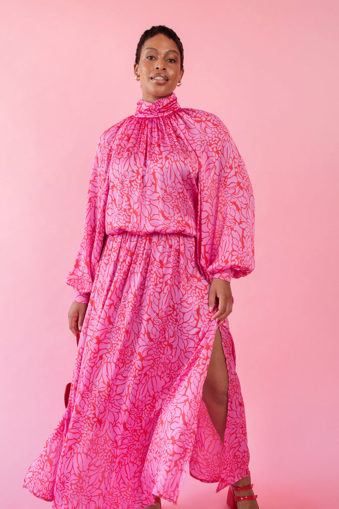 Model wearing pink and red, floral print dress