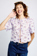 Model wearing lilac tie top and jeans