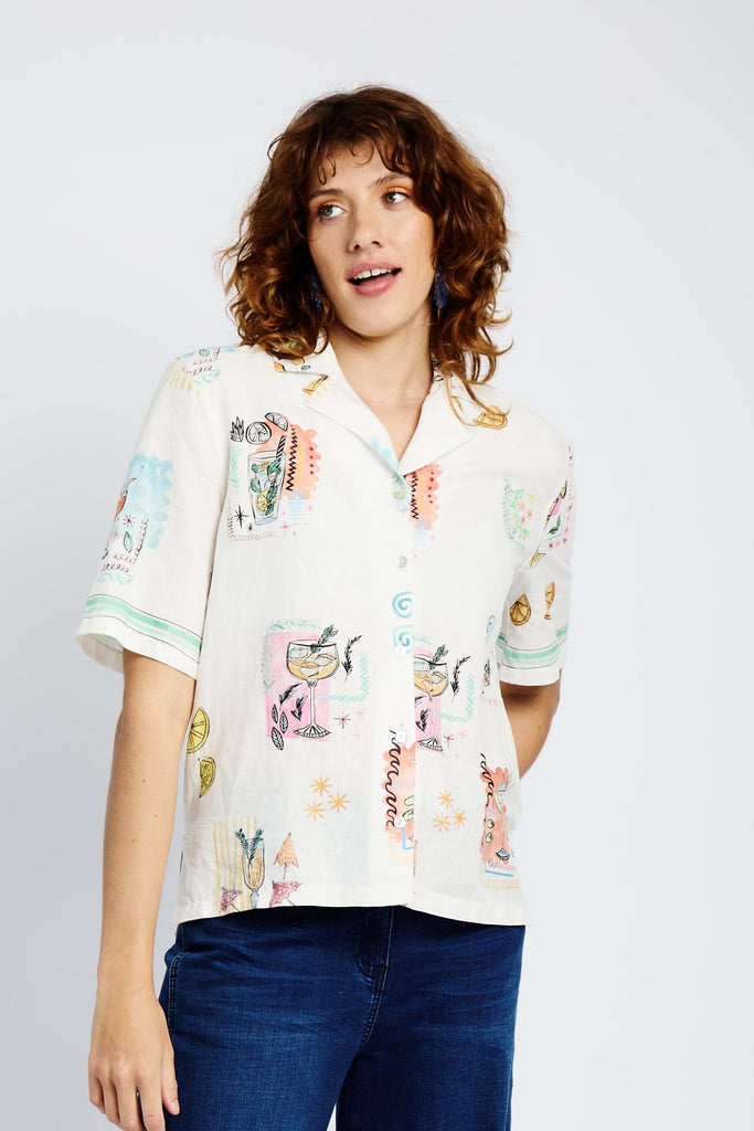 Model wearing a white shirt with cocktail print