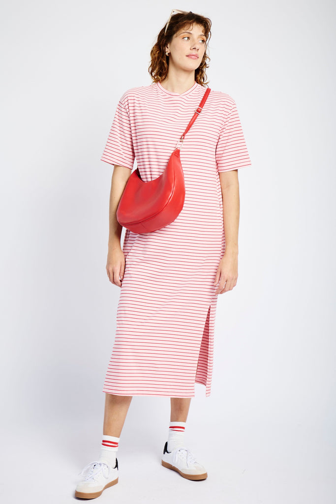 Model wearing a pink and red tee dress, red handbag