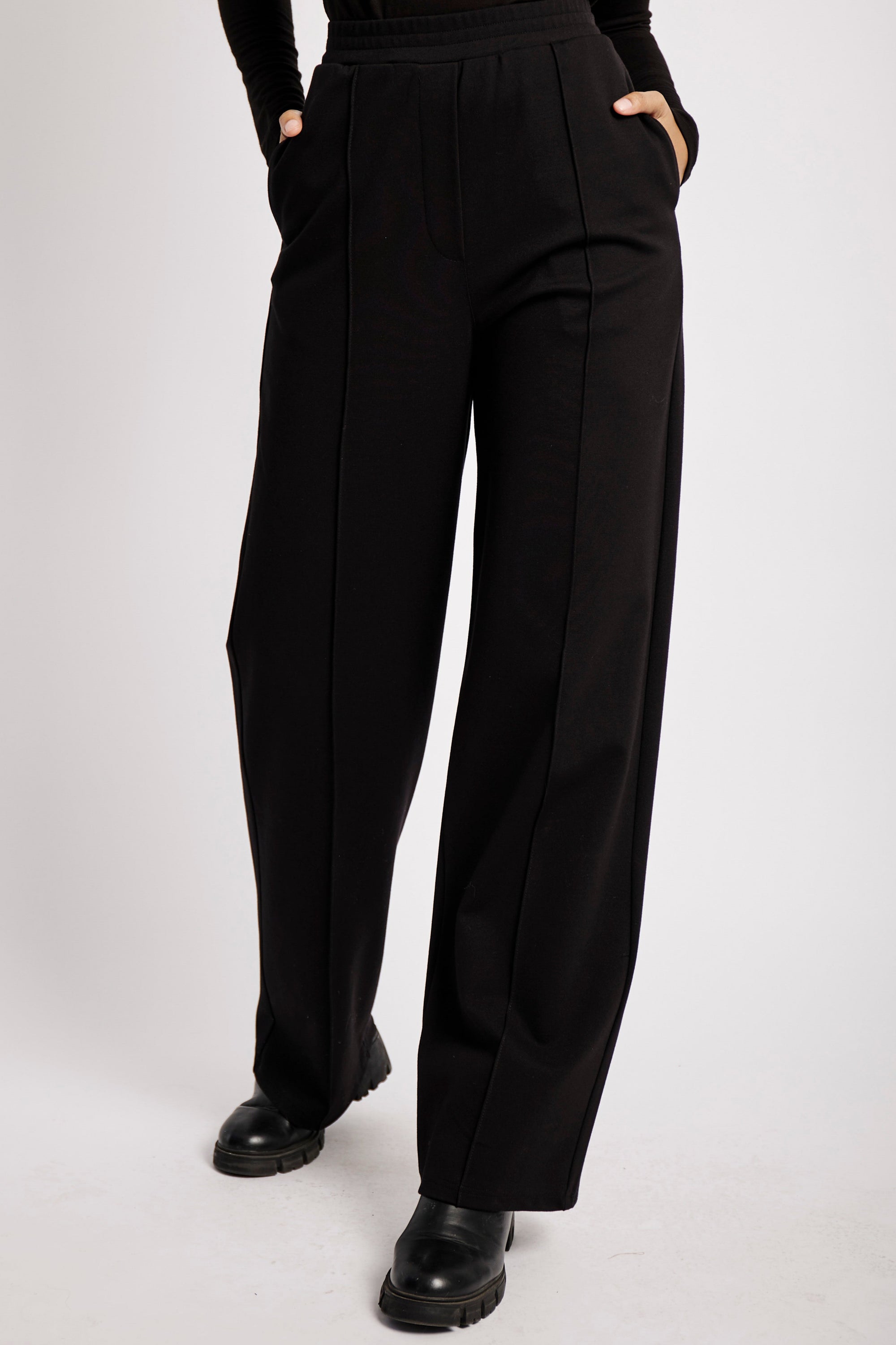 Model wearing black ponti pants and boots