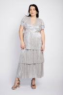 Model wearing silver plisse dress with v neckline and tiered skirt, great for weddings