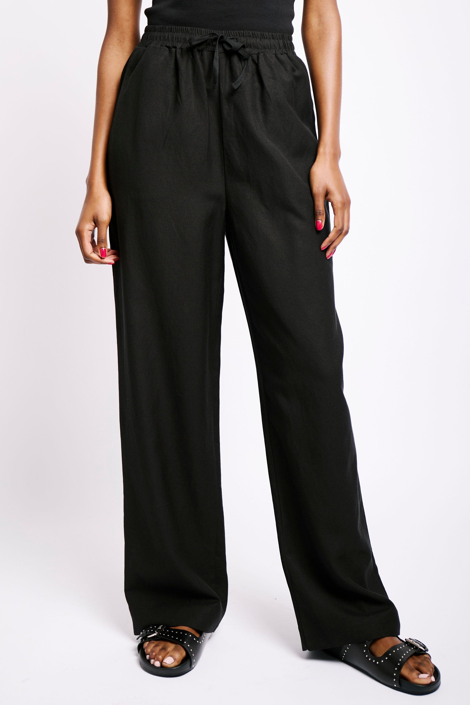Model wearing black linen pants