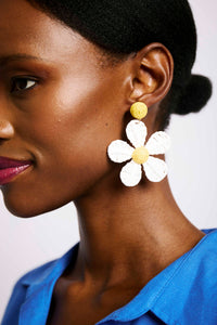 model wearing daisy earring raffia