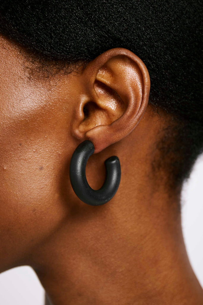 Black polymer clay hoop on model's ear