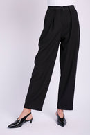 Model wearing tailored black pant with black heel