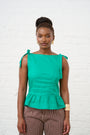Model is wearing a green peplum top 