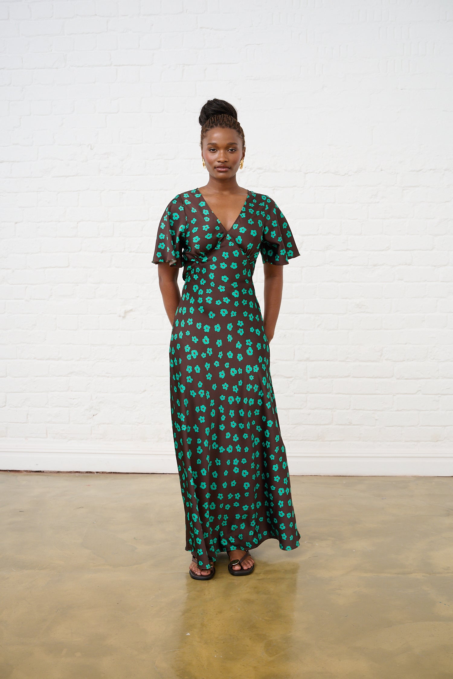Model is wearing a brown and green satin maxi dress with shoes by Me&B