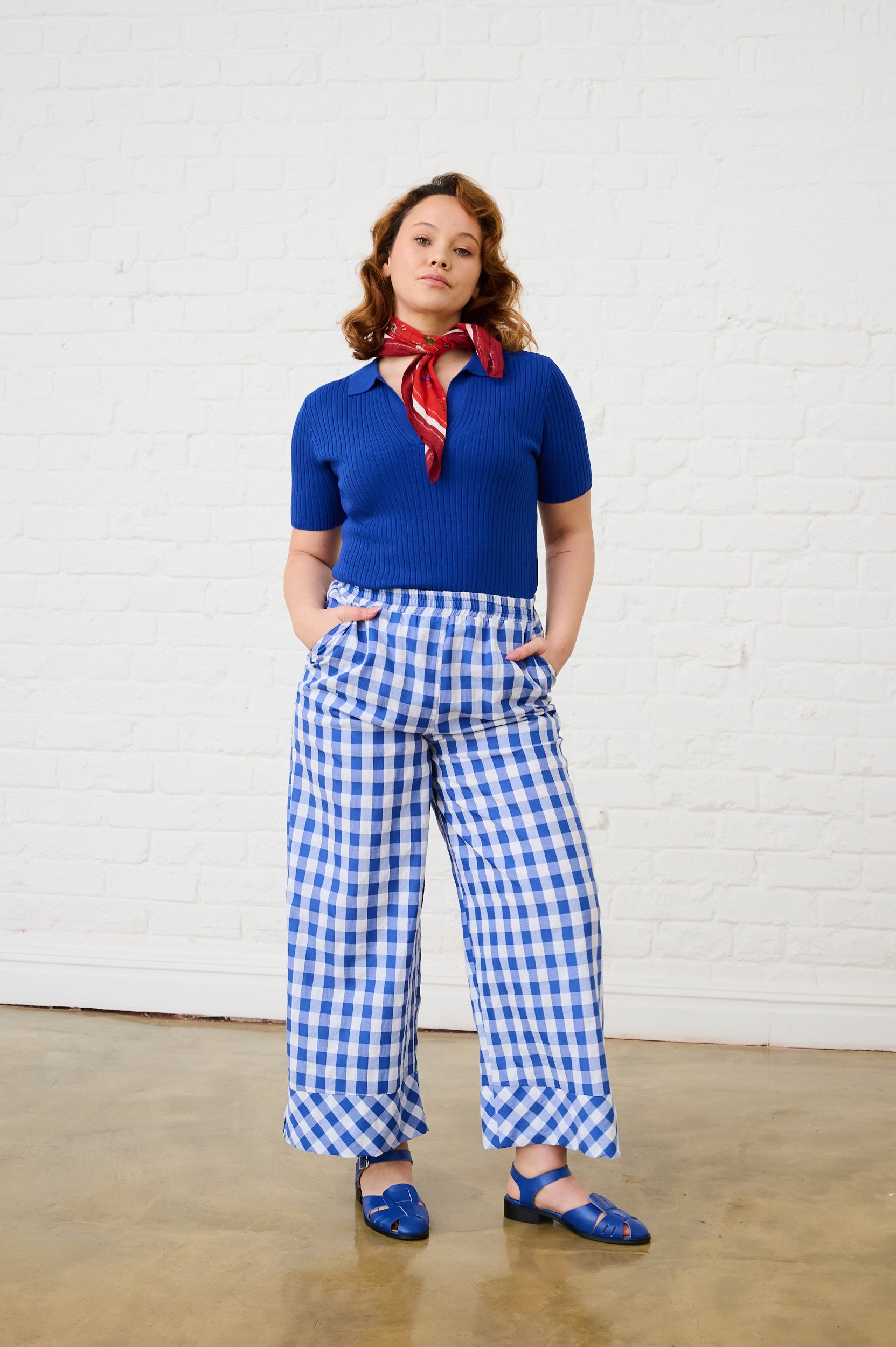 Model is wearing a blue knit top