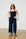 Model is wearing a black cami, turn up jeans and sandals