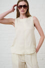 Model is wearing a butter yellow linen sleeveless top with butter yellow linen pants by Me&B