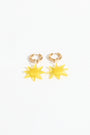 Gold hoop earrings with yellow star-shaped charms on a white background