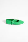Green flat shoe with a strap on a white background