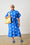 Model is wearing a blue spot maxi dress with a yellow bag an d blue sandals