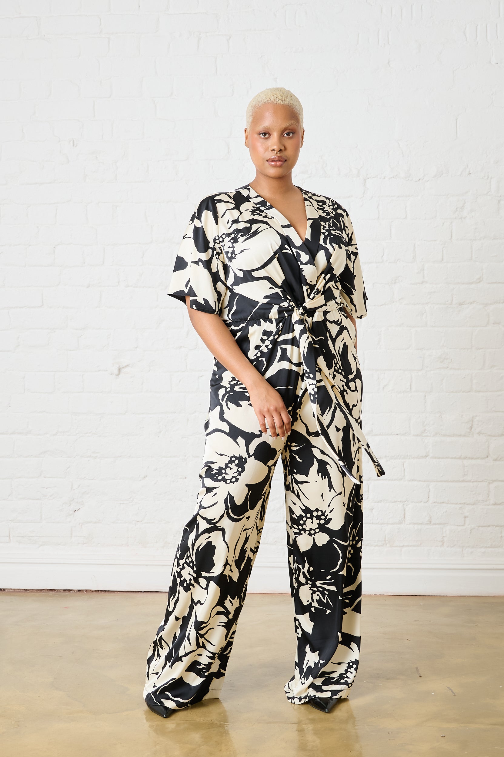 Model is wearing a monochrome jumpsuit in black and white