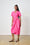 Model is wearing a pink wrap dress with black sandals made by Me&B