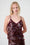Model is wearing a burgundy sequin top 