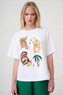 Woman wearing a white t-shirt with colorful graphic designs on a white background