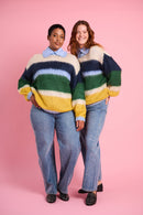 Models are wearing multi stripe fluffy jumper with blue denim jeans 