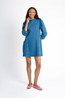 Model is wearing an A-Line mini denim dress with red check shoes