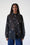 Model is wearing a bellow button down shirt that is slightly sheer with lipstick embroidery 