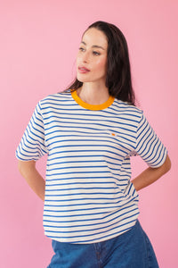 Model wearing blue and white stripe tee with egg embroidery