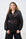 Model is wearing a black and gold sheer bellow sleeve short with black pants 
