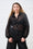 Model is wearing a black and gold sheer bellow sleeve short with black pants 