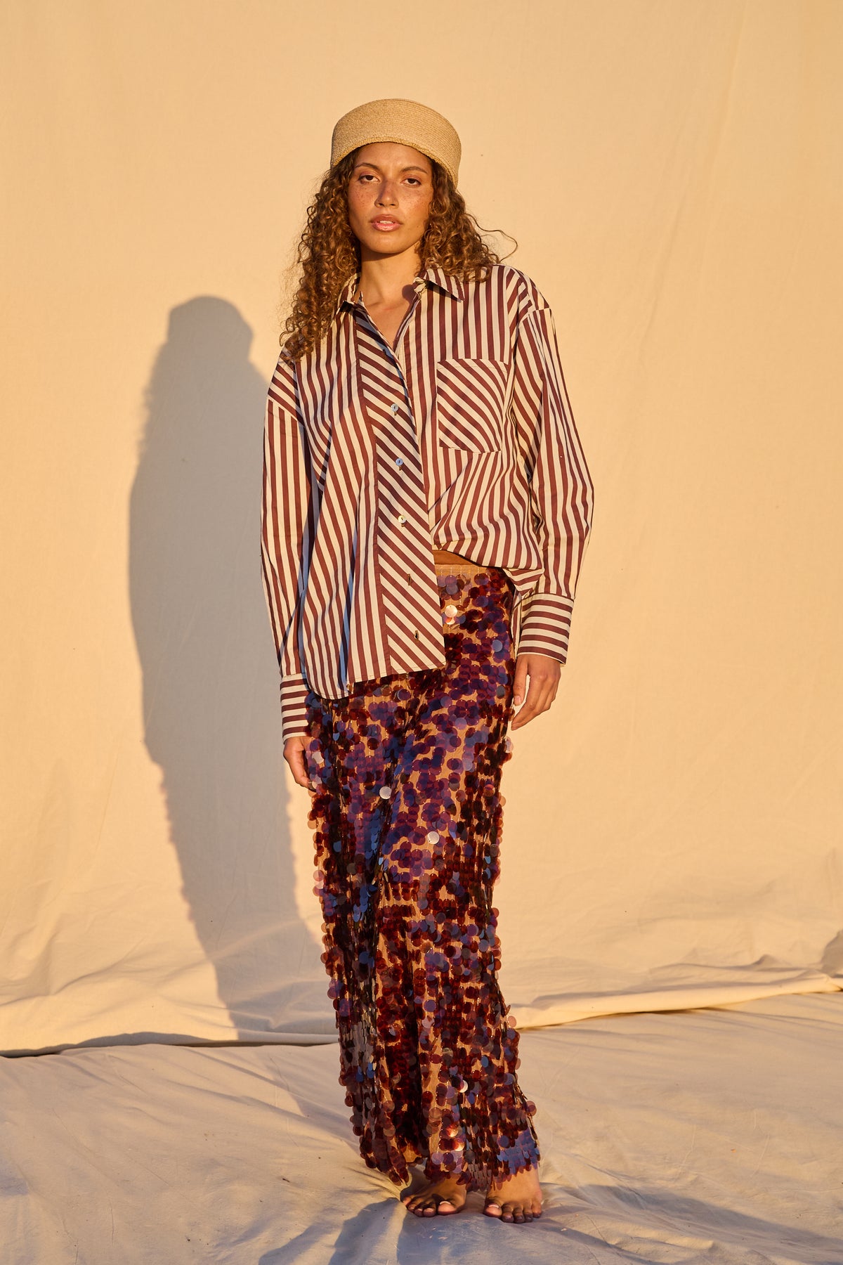 Model is wearing a chocolate brown sequin maxi skirt
