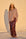 Model is wearing a chocolate brown sequin maxi skirt
