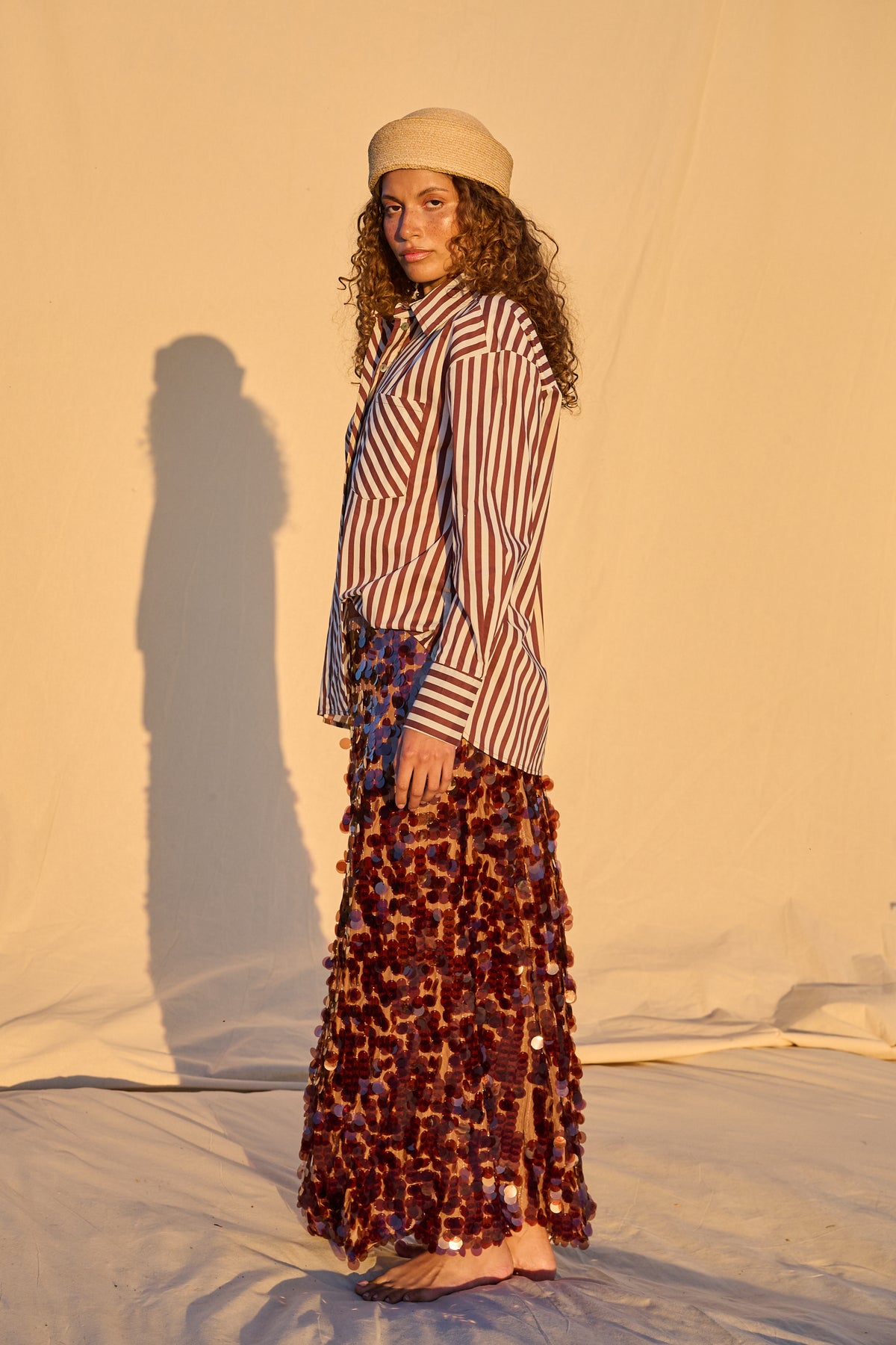 Model wearing a chocolate brown sequin maxi skirt