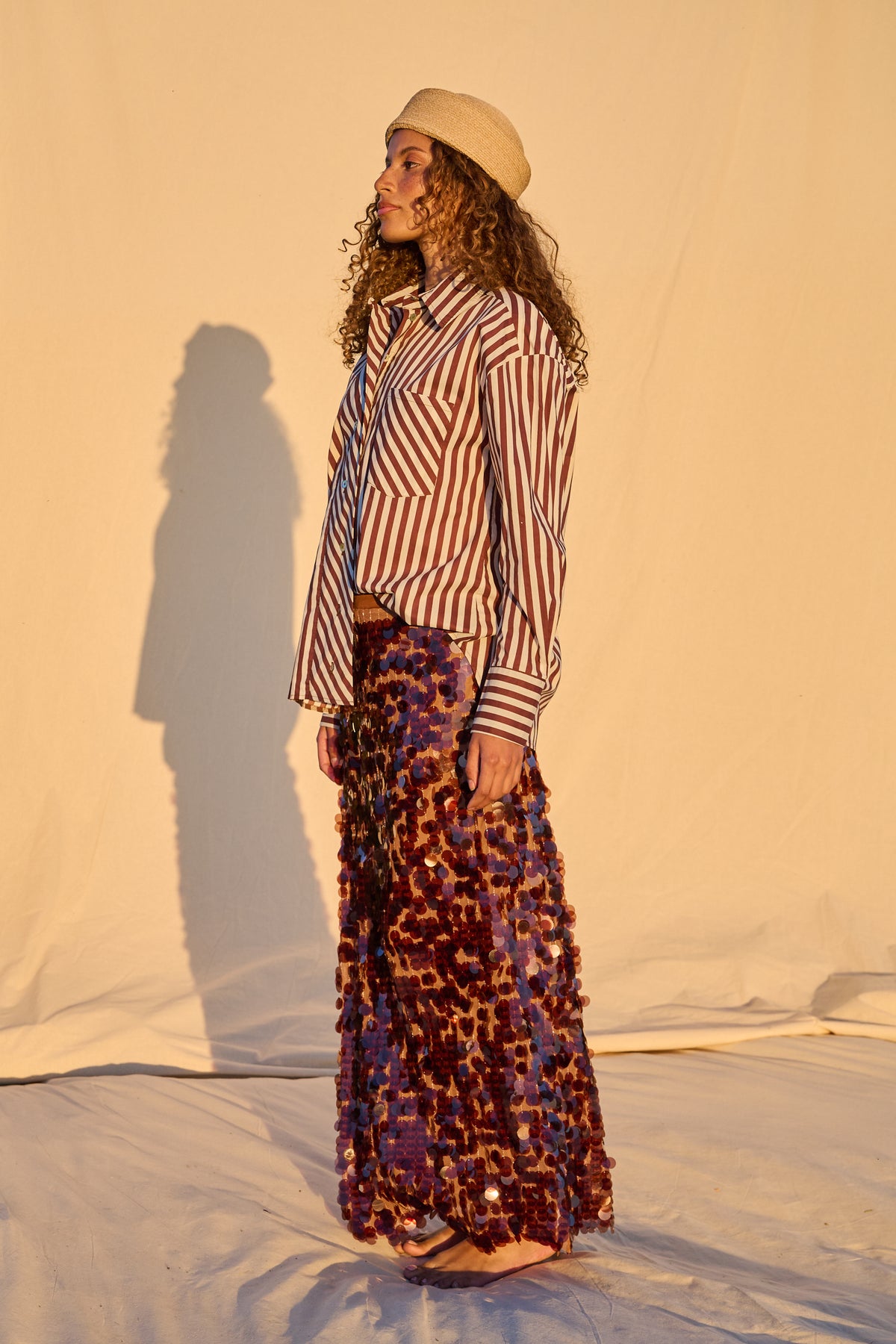 Model wearing a chocolate brown sequin maxi skirt