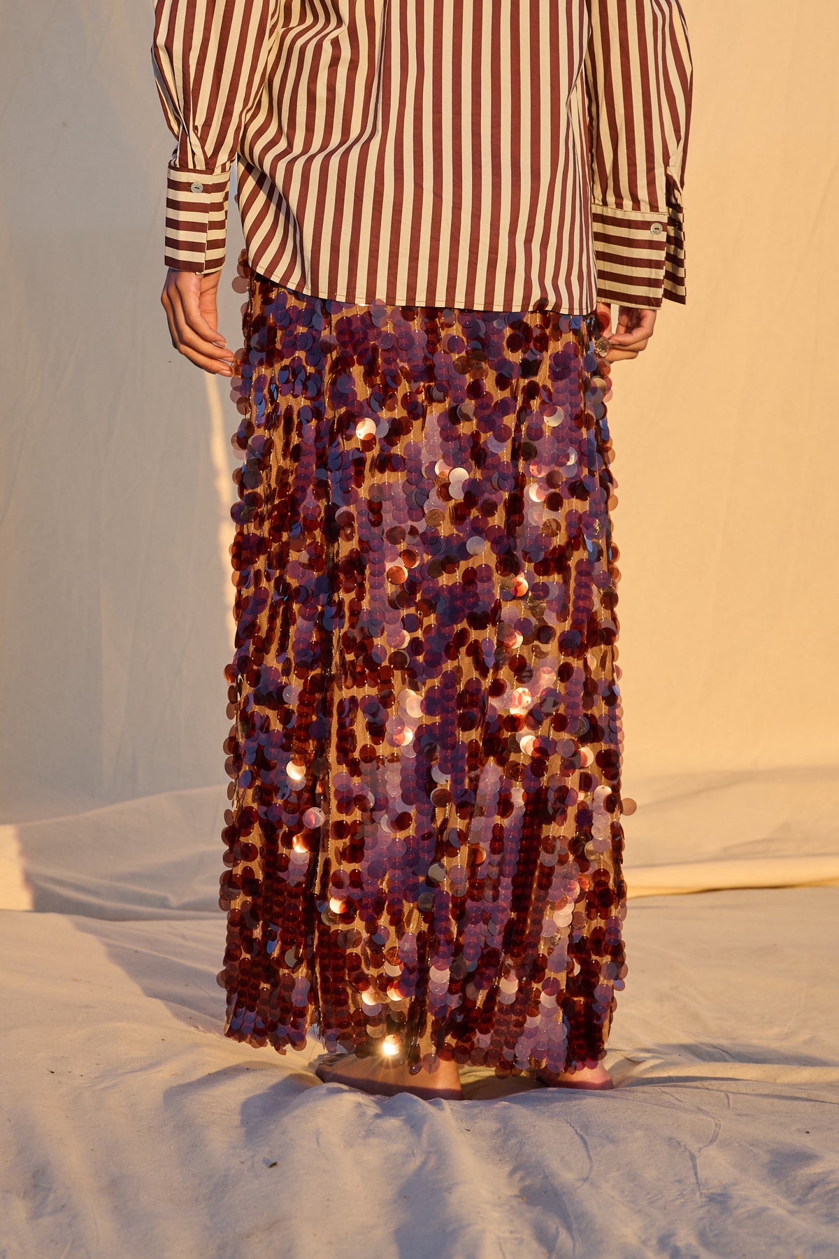 Model wearing a chocolate brown sequin maxi skirt