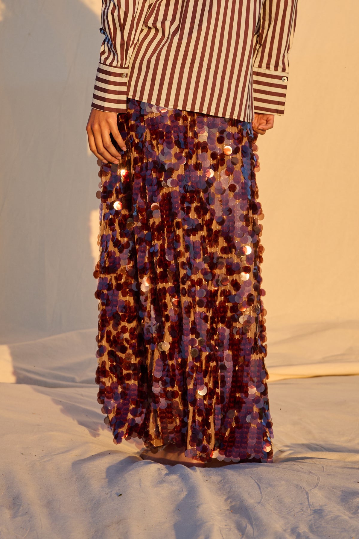 Model wearing a chocolate brown sequin maxi skirt