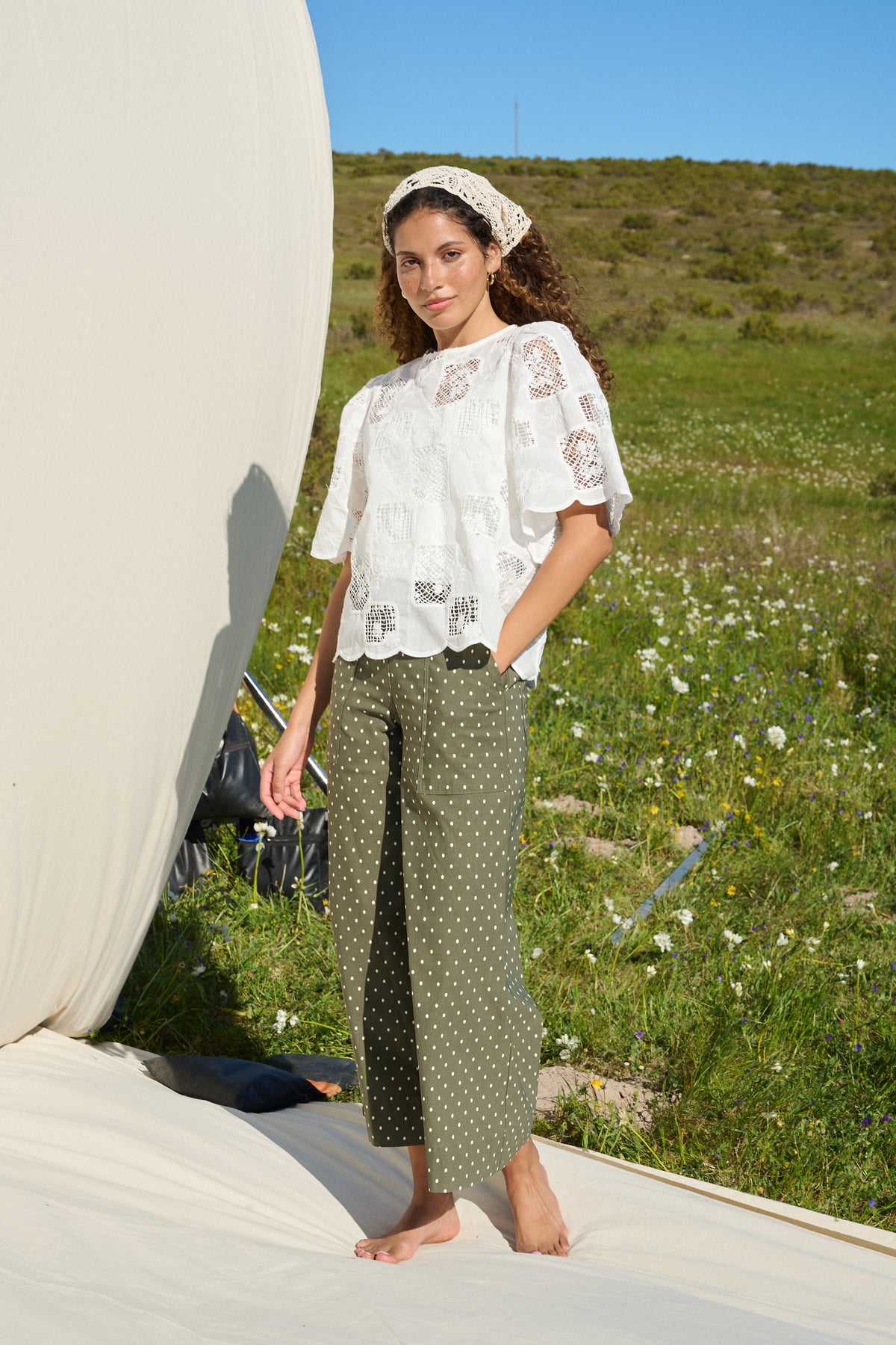 Model wearing milk white lace tee with scalloped sleeves and hem